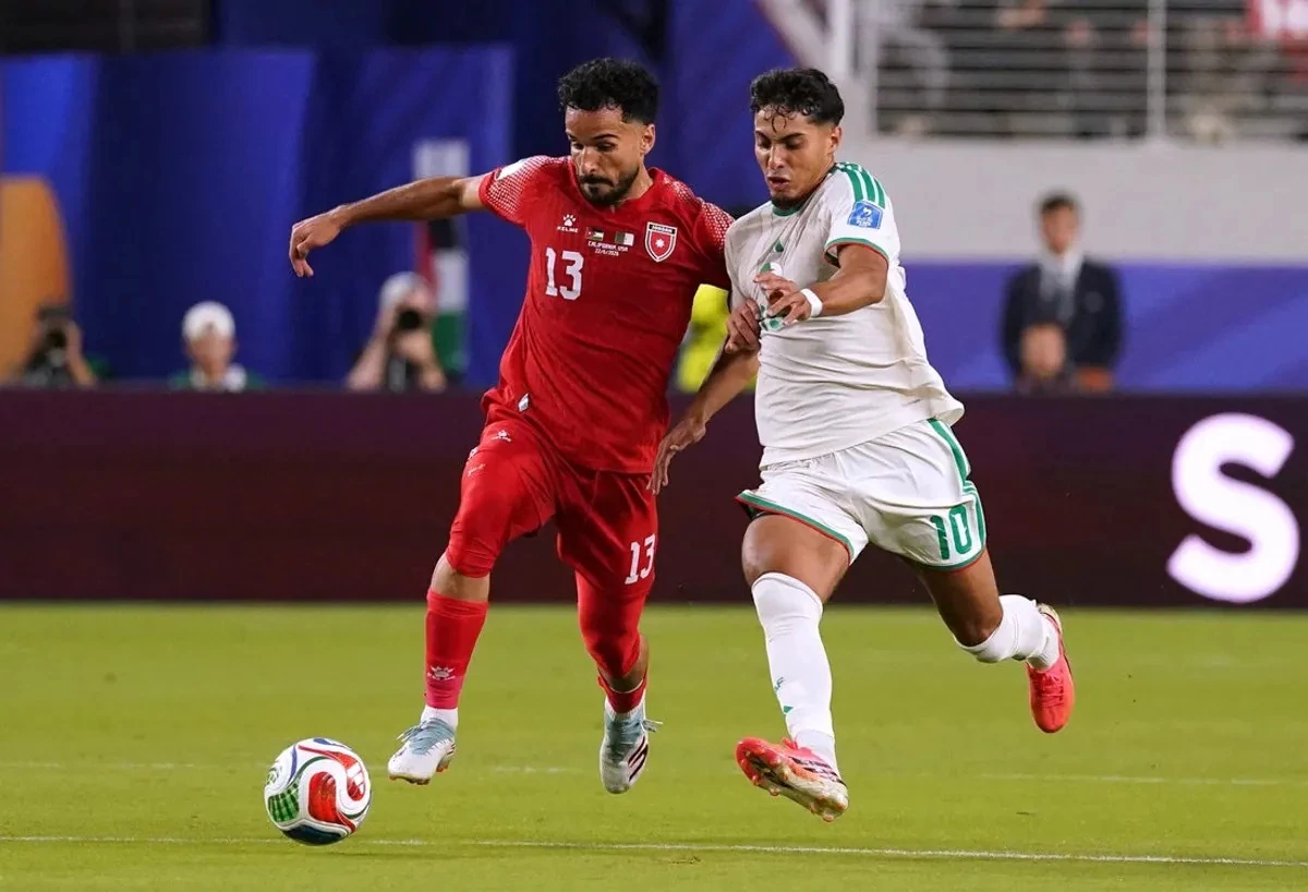 Jordan's Mahmoud Almardi in action with Algeria's Fares Chaibi