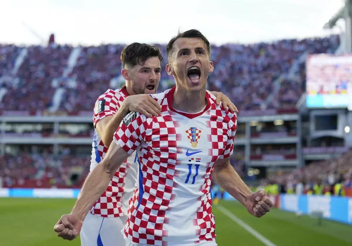 Croatia's Ante Budimir celebrates scoring their first goal with Martin Baturina