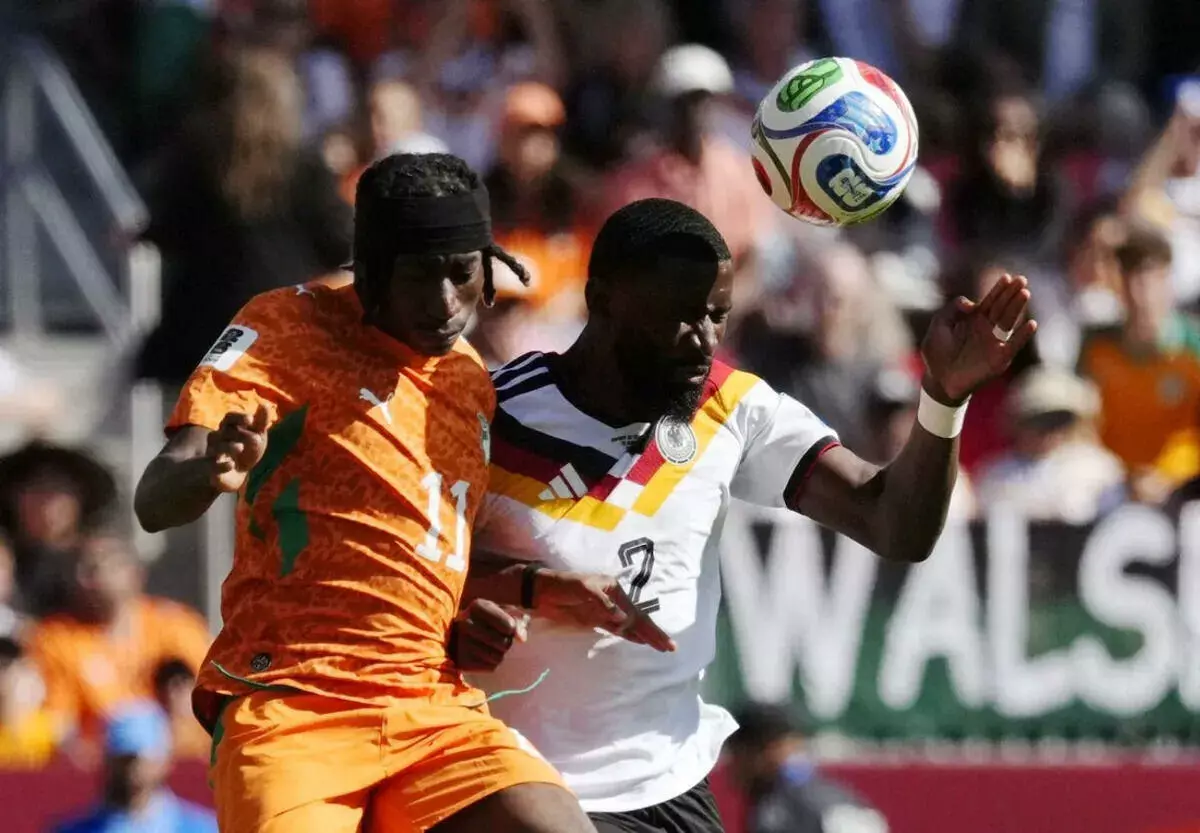Ivory Coast's Yan Diomande in action with Germany's Antonio Rudiger