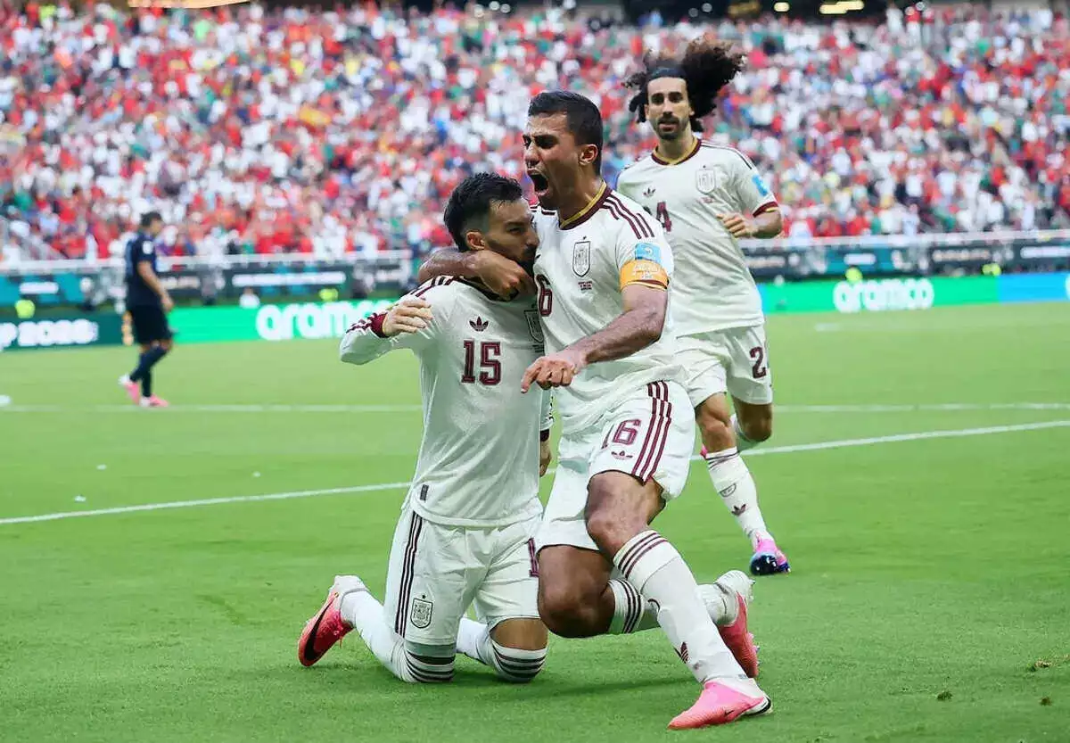 Spain's Alex Baena celebrates scoring their first goal against Uruguay with Marc Cucurella and Rodri.
