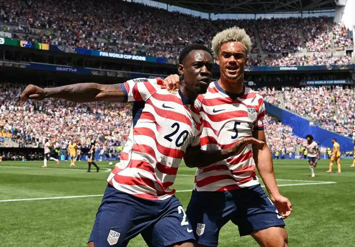 Folarin Balogun and Antonee Robinson celebrate the USA's first goal against Australia