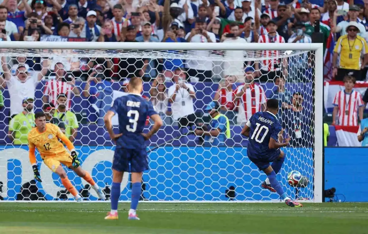 France's Kylian Mbappe scores a penalty against Paraguay at the World Cup