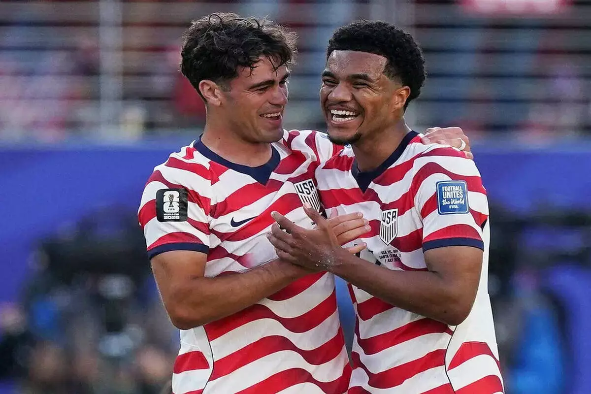 USMNT's Giovanni Reyna and Malik Tillman celebrate after Round of 32 win