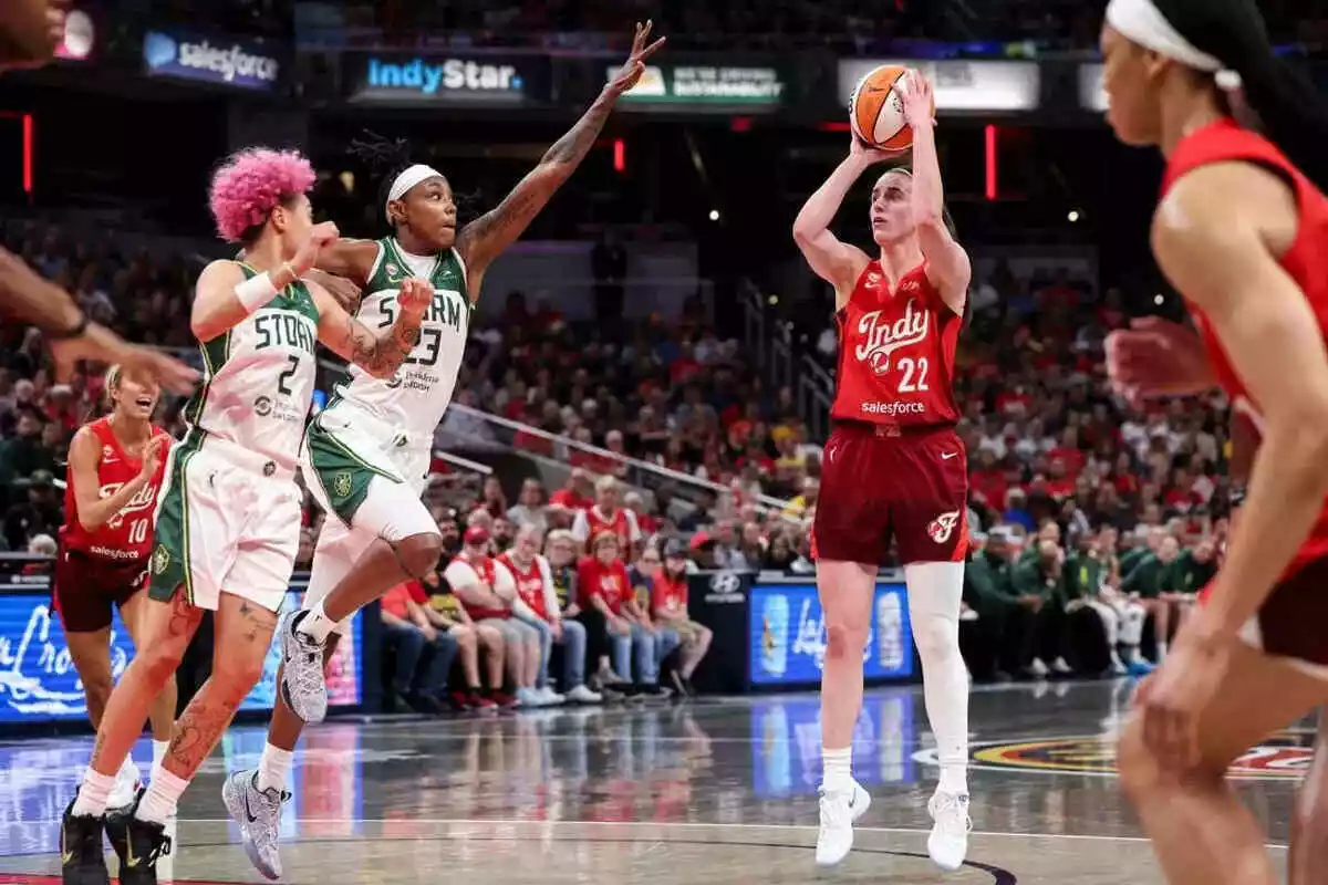 Indiana Fever guard Caitlin Clark attempts a shot vs Storm