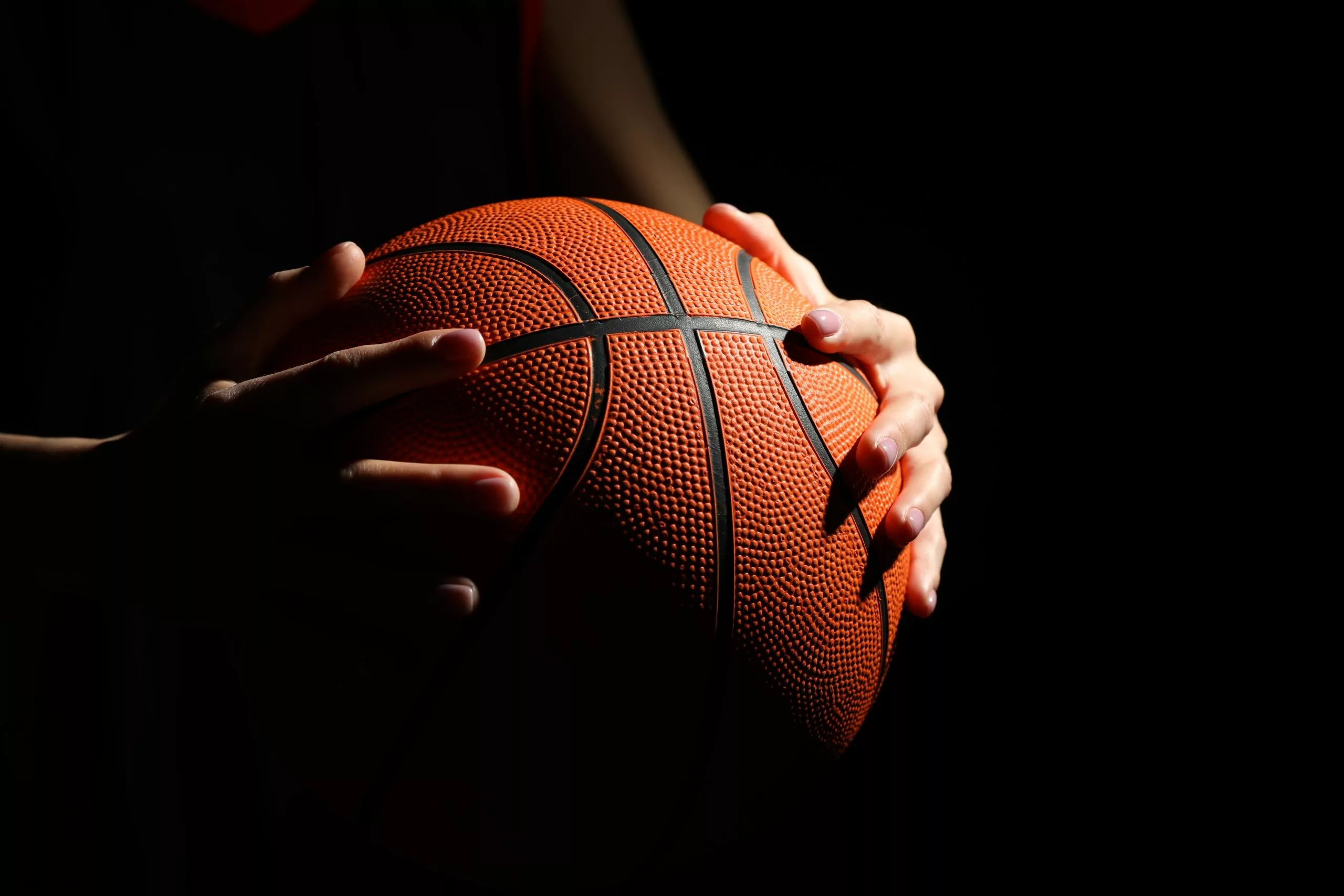 Basketball,Player,With,Ball,On,Black,Background,,Closeup
