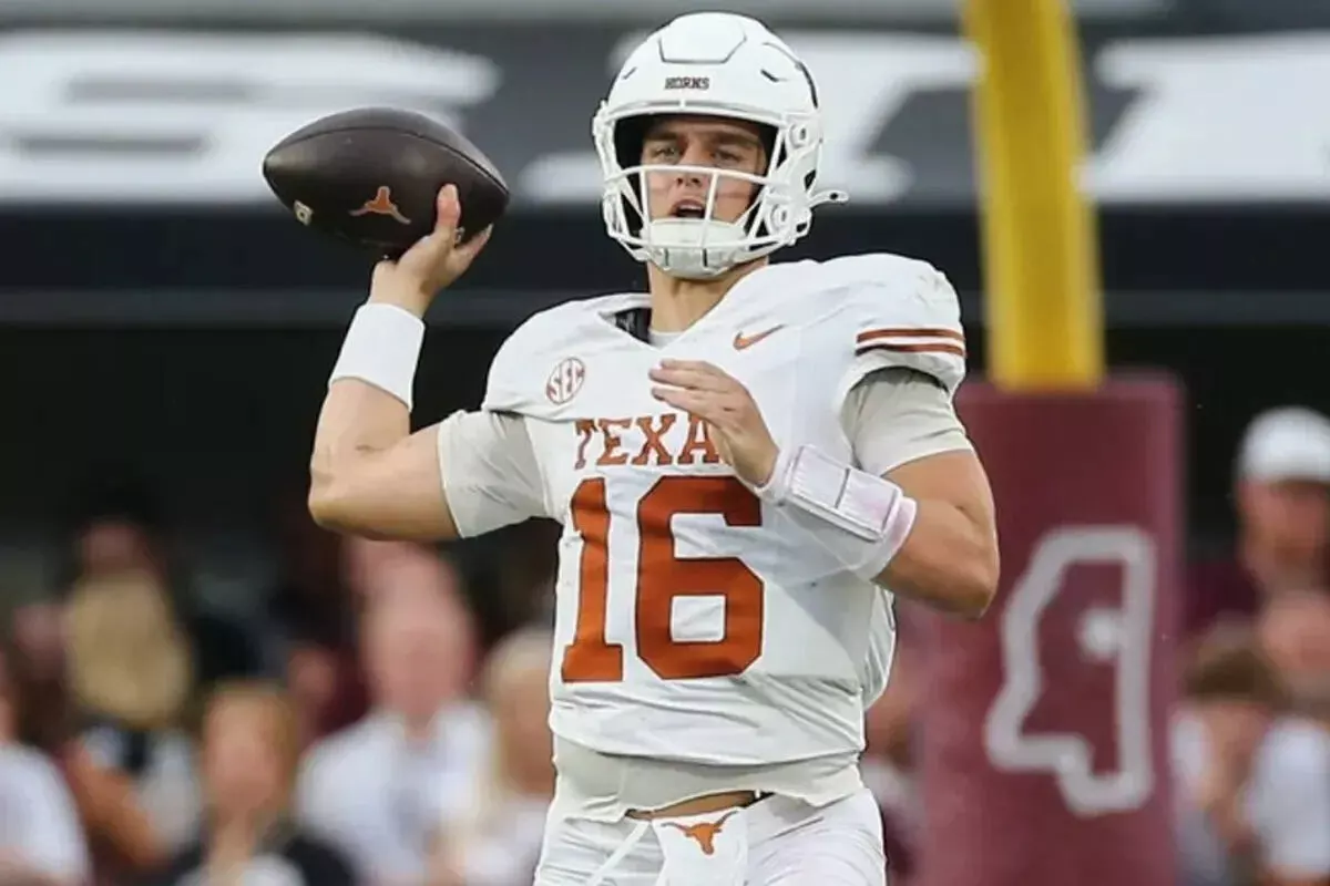 Texas quarterback Arch Manning goes to throw a pass