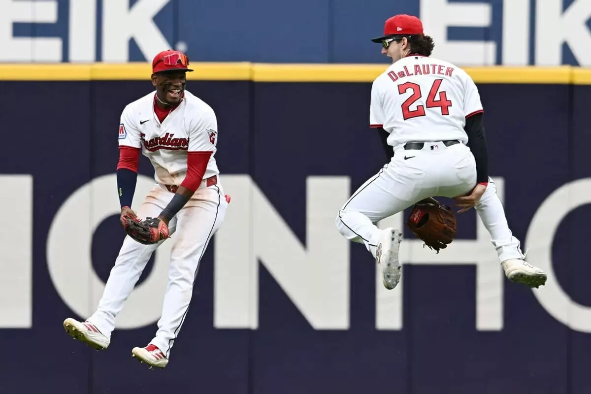 Cleveland Guardians left fielder Angel Martinez and right fielder Chase DeLauter celebrate