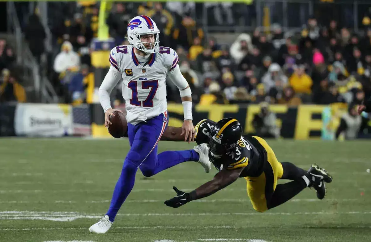 Bills quarterback Josh Allen runs from Steelers defender