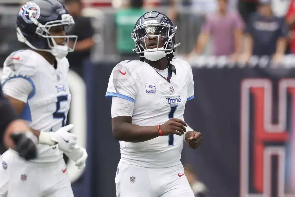 Tennessee Titans quarterback Cam Ward looks up while walking off the field
