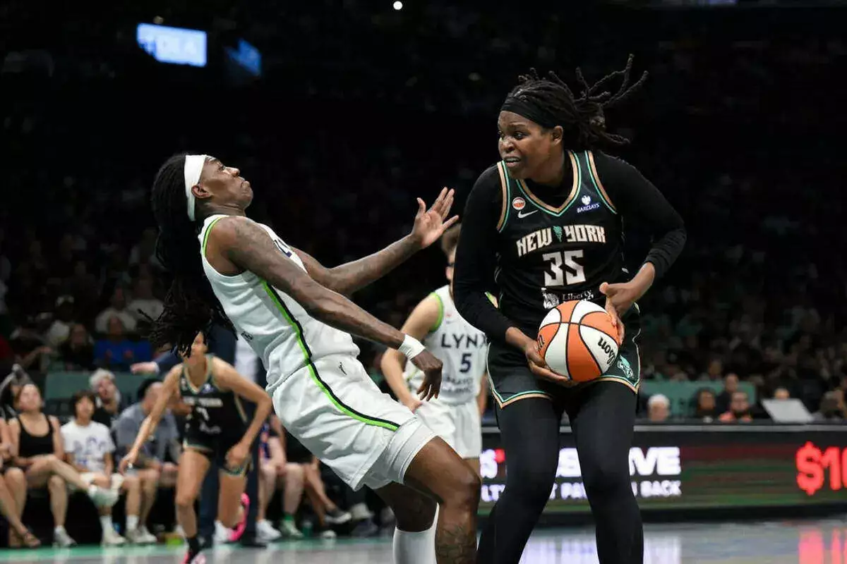 New York Liberty center Jonquel Jones posts up against Minnesota Lynx forward Natasha Howard