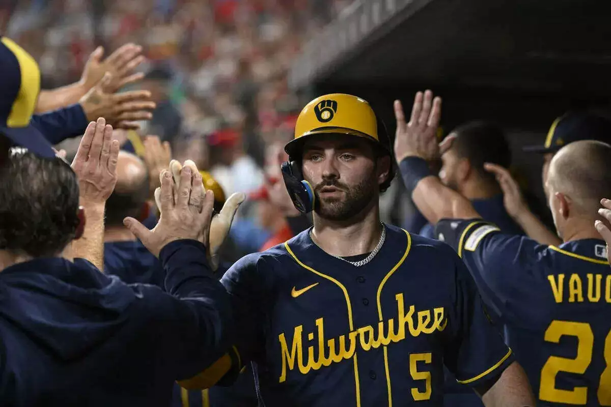 Milwaukee Brewers center fielder Garrett Mitchell is congratulated by teammates