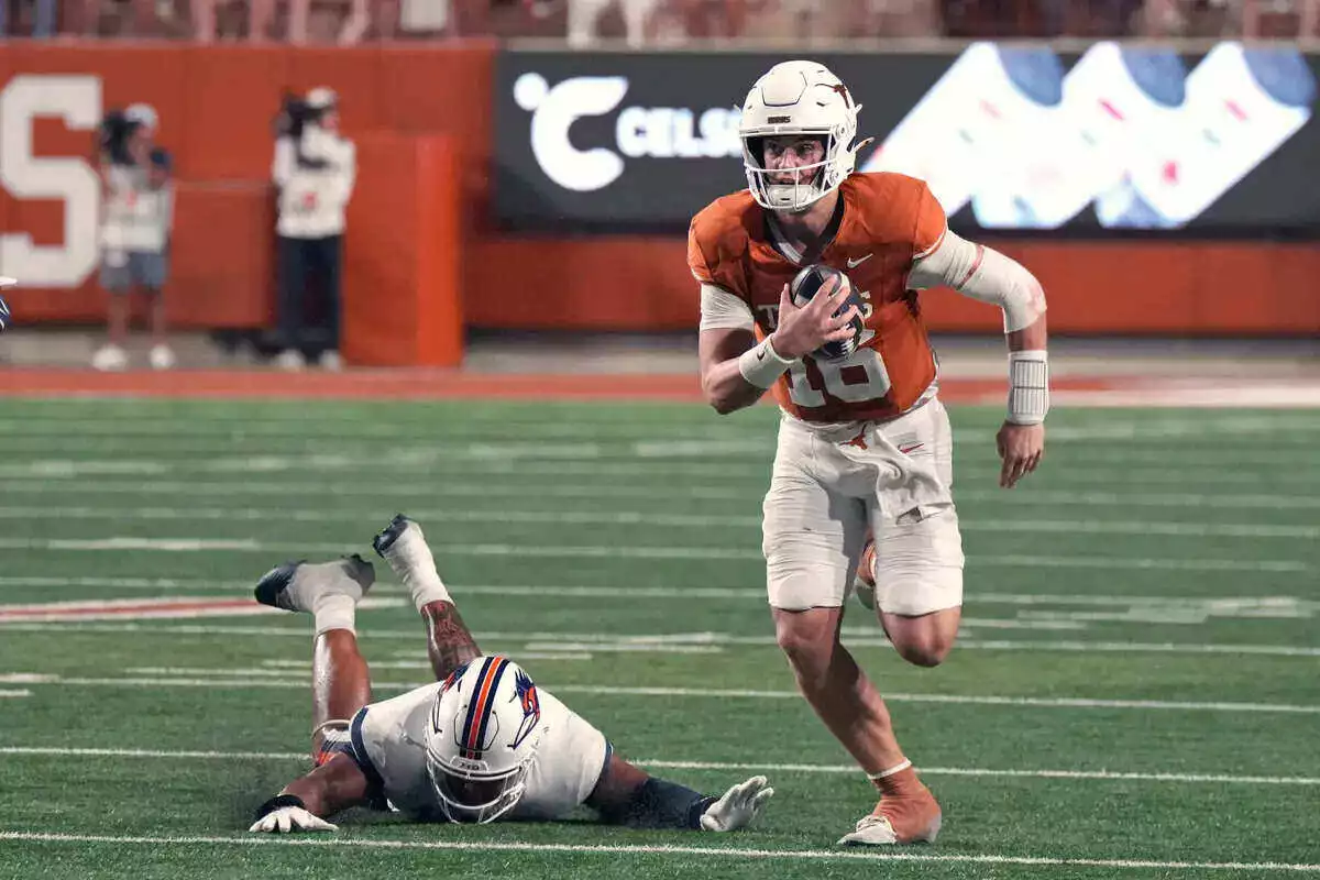 Texas Longhorns quarterback Arch Manning runs with the ball