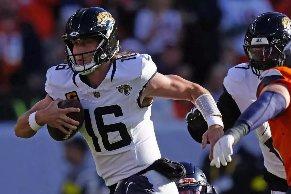 Jaguars quarterback Trevor Lawrence runs away from a Broncos defender