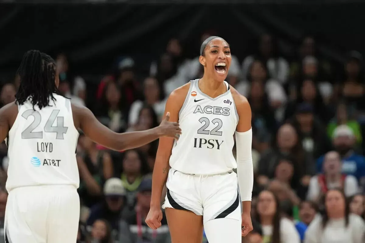 Aces center A’ja Wilson reacts after scoring while drawing a foul